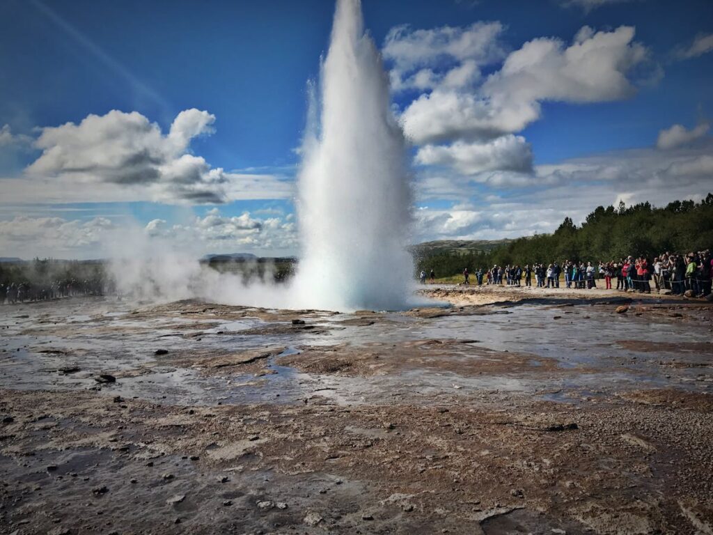 People Watching a Geyser Eruption