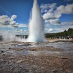 People Watching a Geyser Eruption